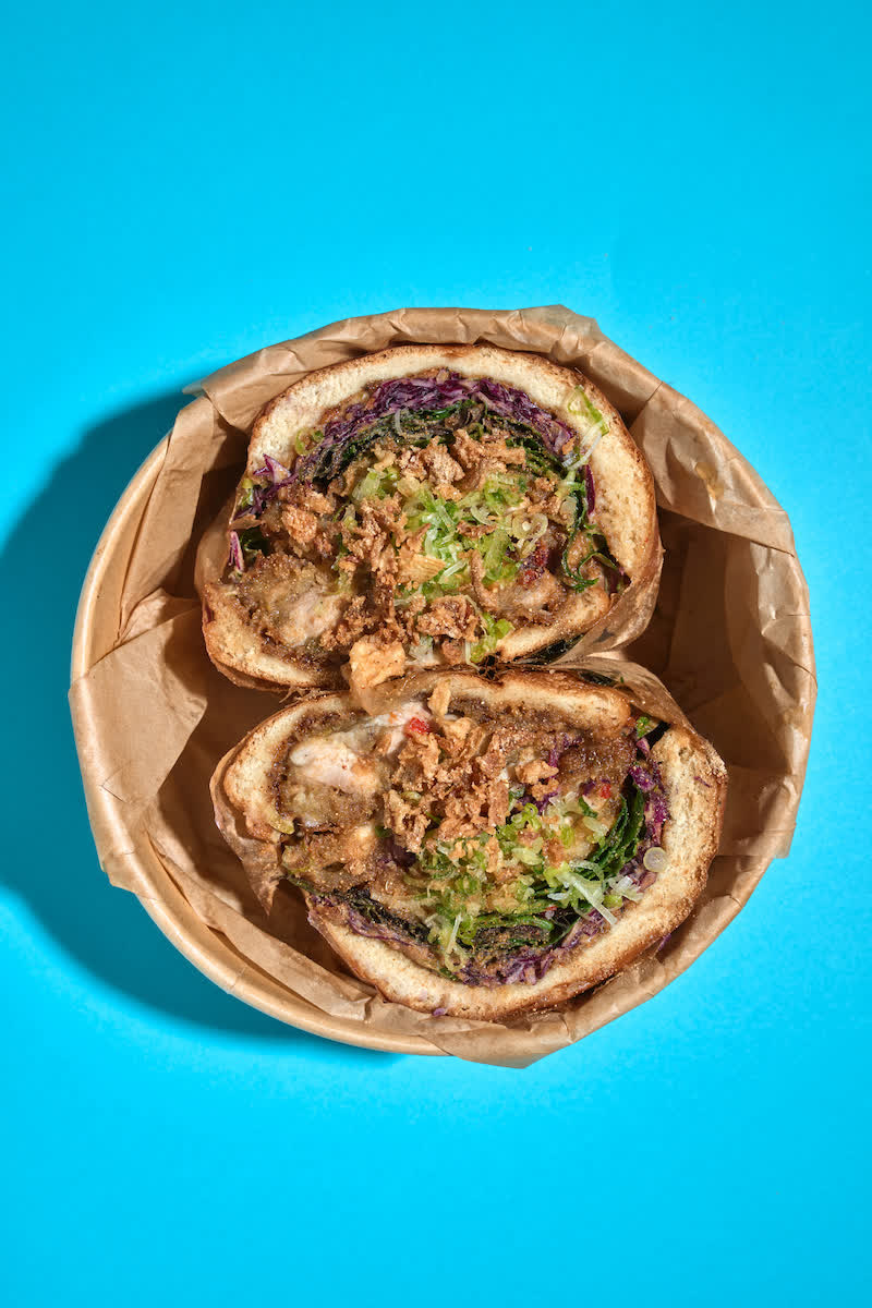 Mae Tao OG sandwich in a parchment takeout bowl