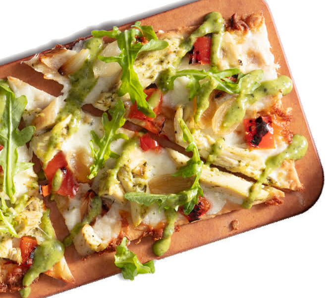 Seasons 52 chicken-pesto flatbread on a wooden board